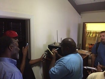 Students meter the electricity consumption of appliances during an energy audit of a Virgin Islands home.