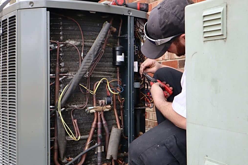 service-repair-being-done-on-a-heat-pump-hvac-system